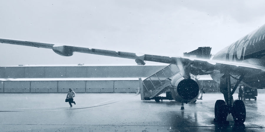 person next to plane in the rain