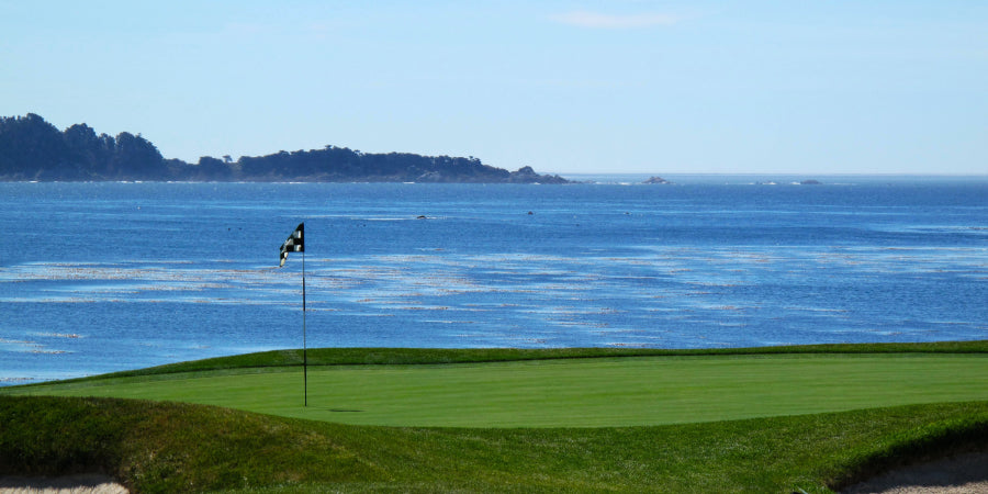Golf green next to body of water
