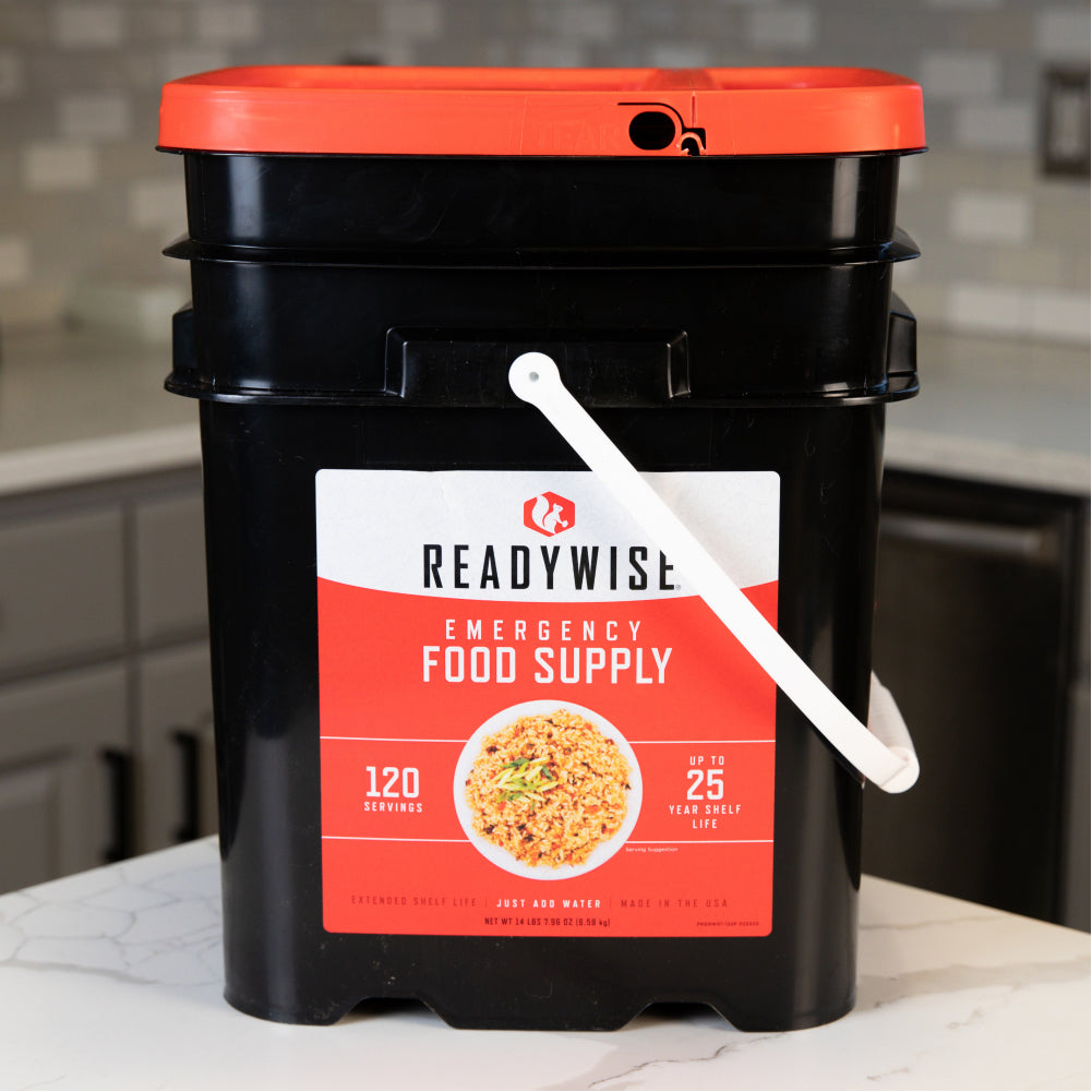 Readywise emergency food bucket with lunch and dinner meals on a kitchen table